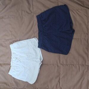 Girls Cat & Jack eyelet shorts. One white, one navy. Size large (10-12)